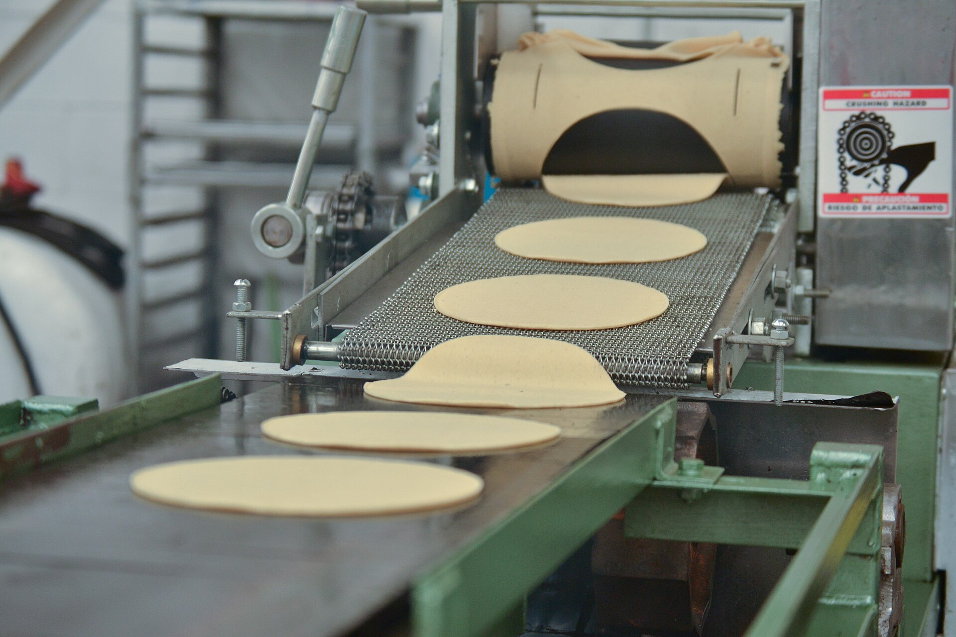 Tortilladora industrial sacando tortillas por la banda